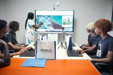 Young La Brea community members learning in the training room of the ICT Access Centre.